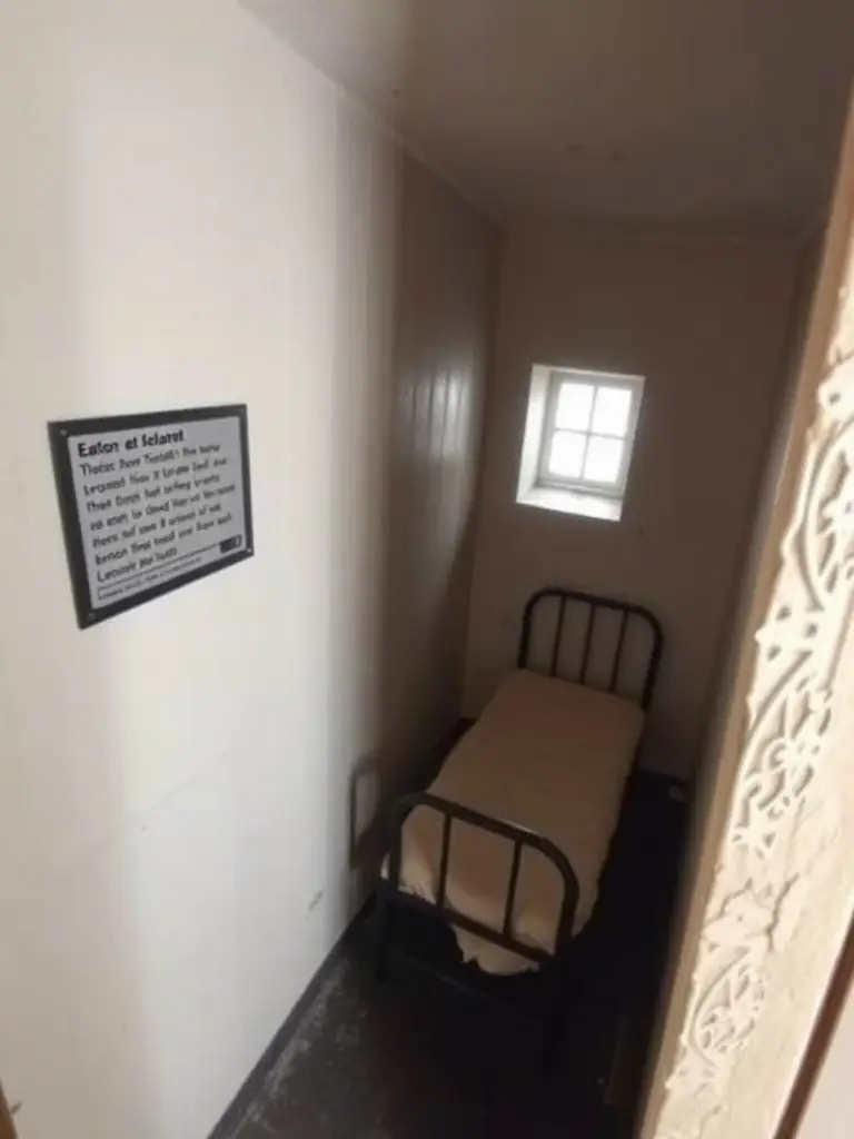 A detailed image of the cell where Eamon de Valera was held, part of the 'Prison Life' exhibit, showing the stark conditions.
